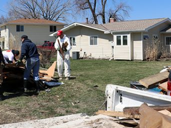 Disaster response volunteers from Habitat Omaha and Team Rubicon