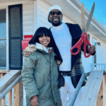 Fontroy, right and his partner, outside his mother’s former home that now belongs to him.