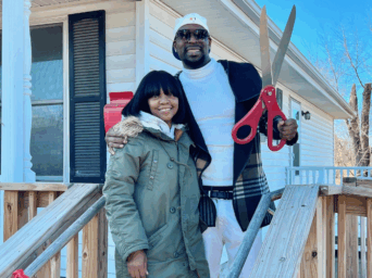 Fontroy, right and his partner, outside his mother’s former home that now belongs to him.