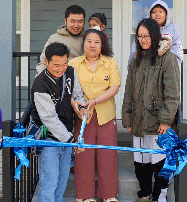 Homeownership in Omaha, homeowner cutting ribbon of house